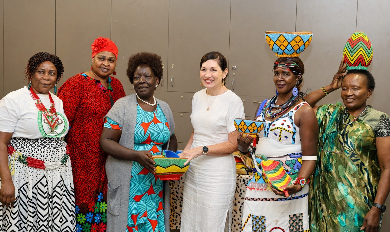 Women in colorful traditional clothing holding baskets